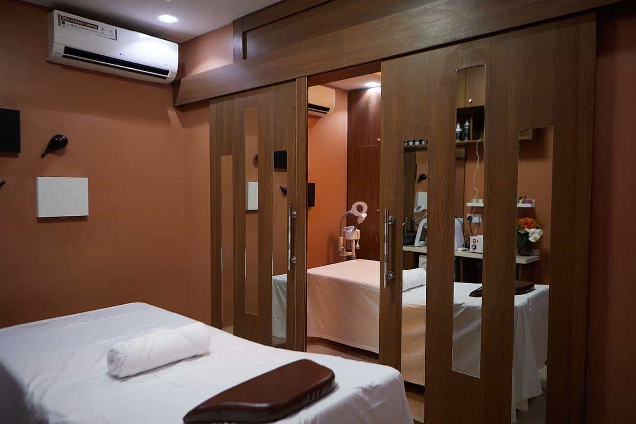 Modern massage treatment room with mirrored doors