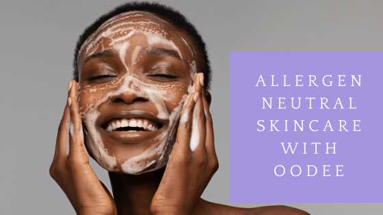 Smiling woman applying foaming cleanser, Oodee skincare advert