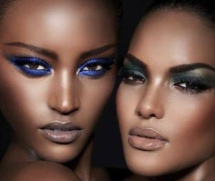 Close-up of two women with dramatic eye makeup