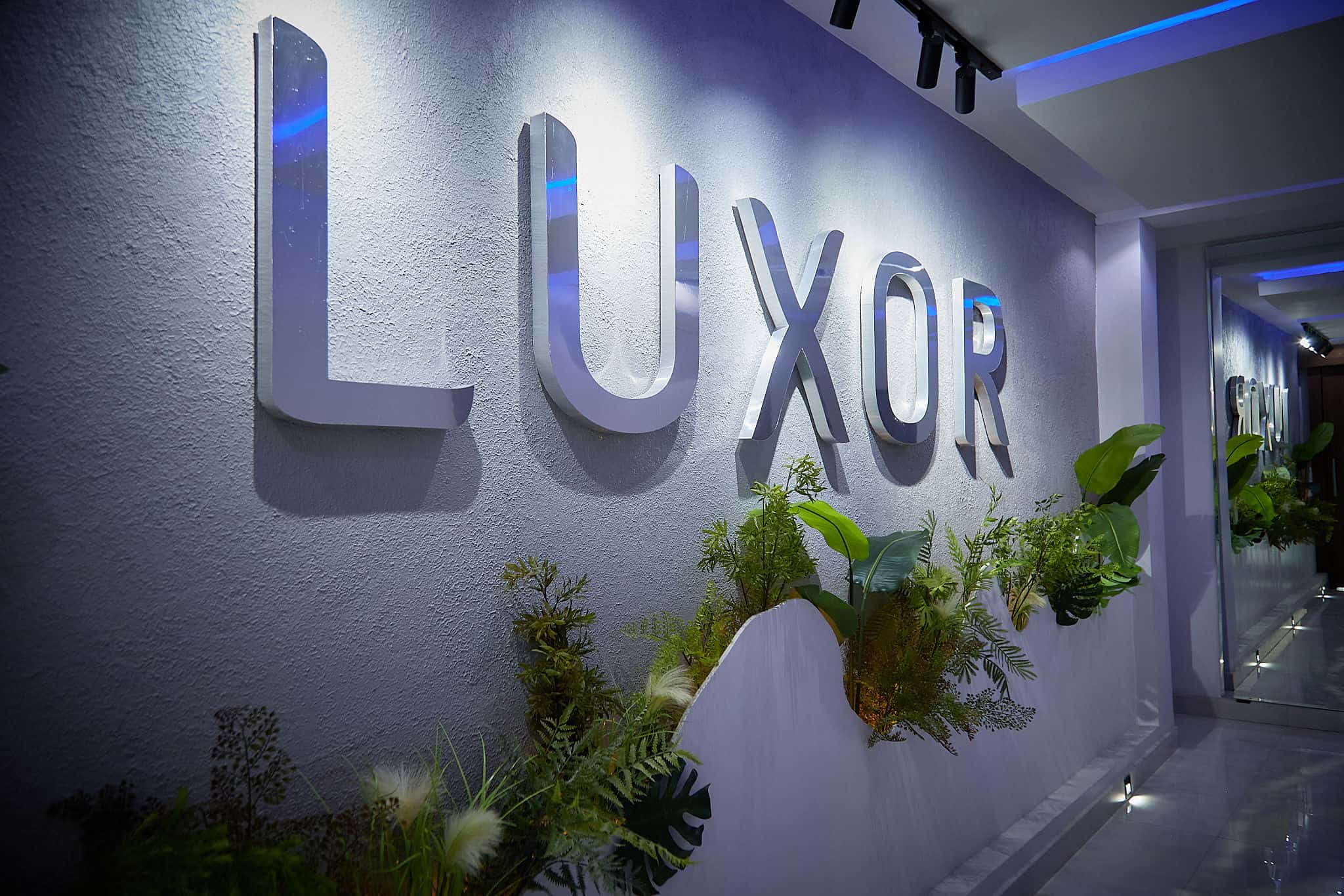 LUXOR wall sign in modern interior corridor