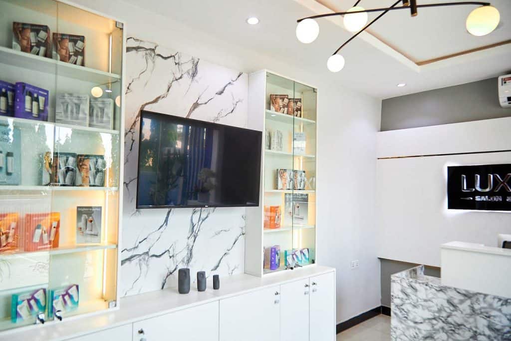 Modern salon interior with marble wall and display shelves