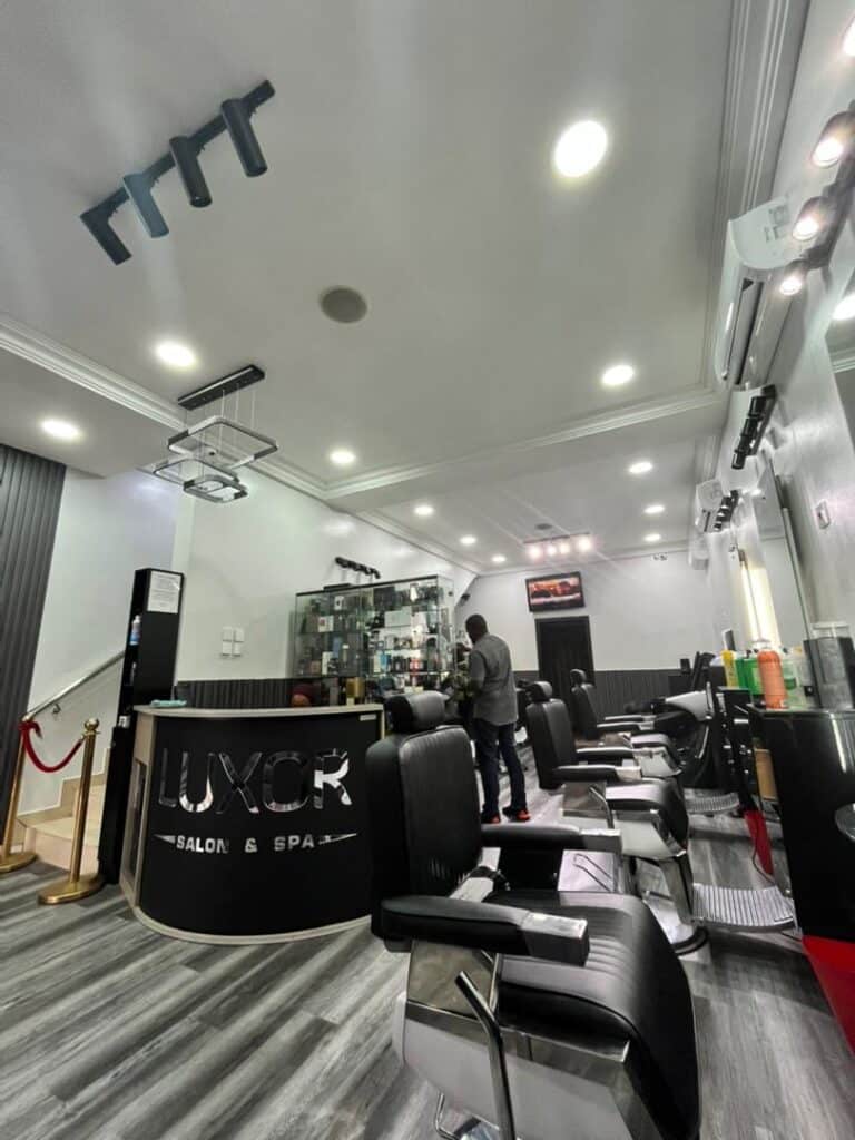 Modern barbershop interior with black chairs and reception