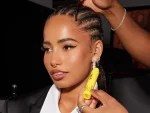 Woman with braided hair wearing large gold earring