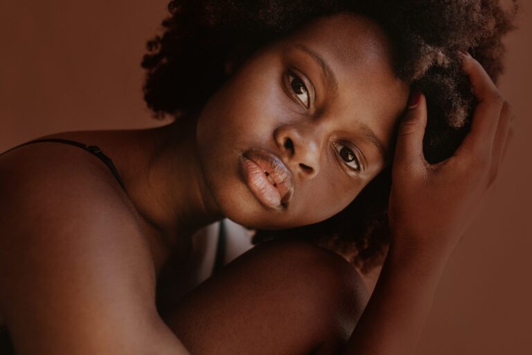 Close-up portrait of woman with natural curly hair