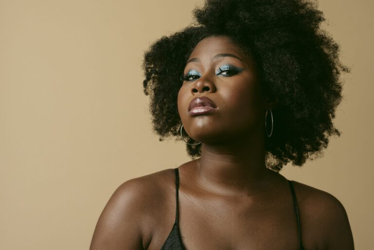 Woman with natural afro hairstyle and blue eyeshadow