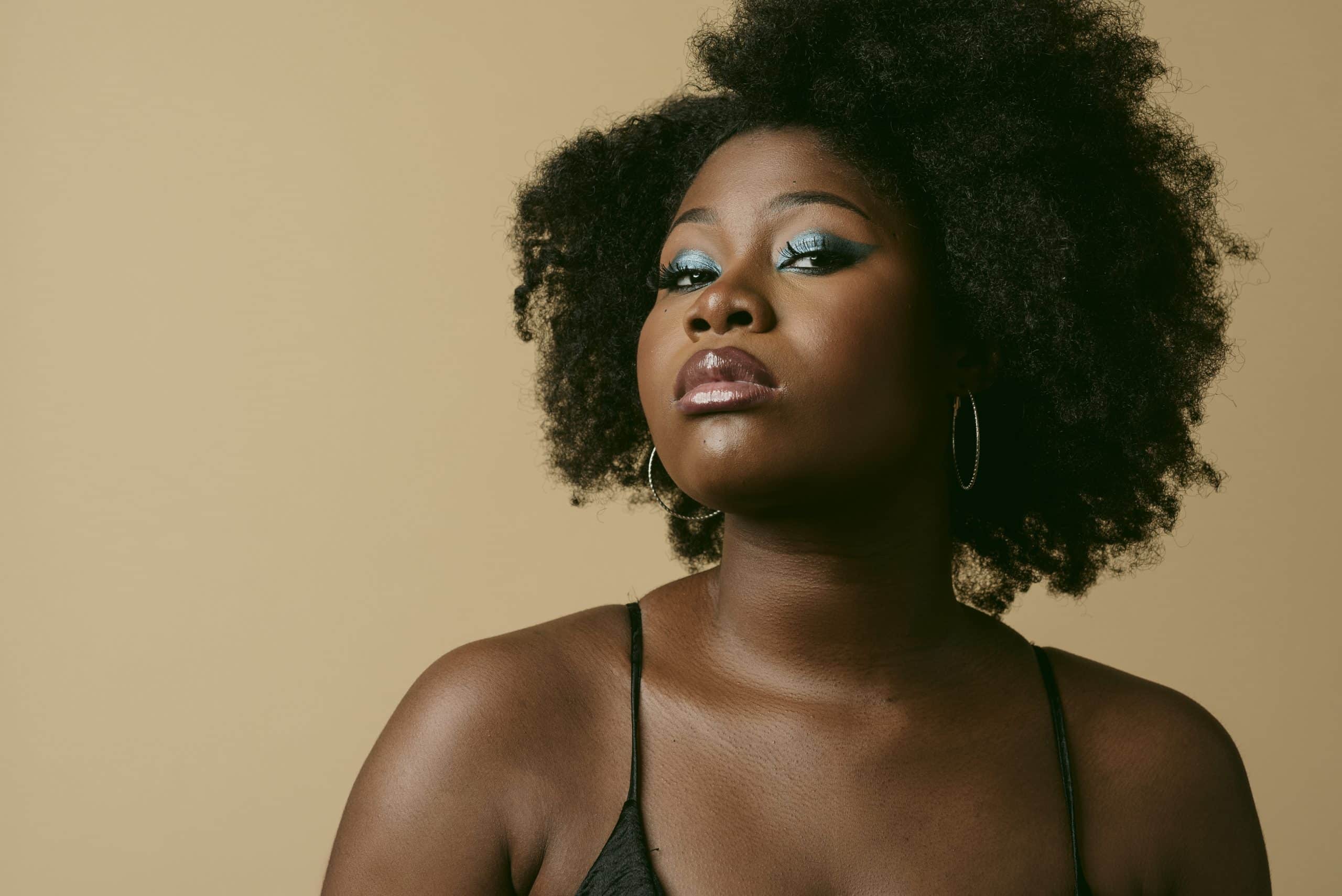 Woman with natural afro hairstyle and blue eyeshadow
