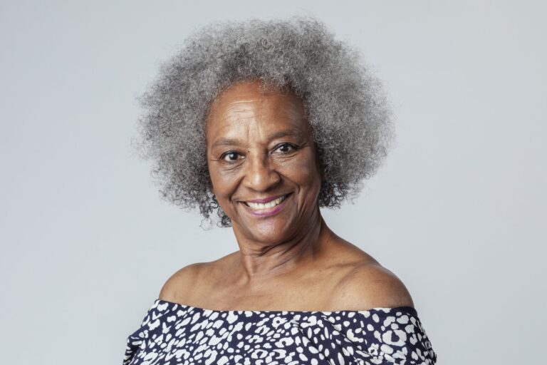 Smiling older woman with grey curly hair portrait