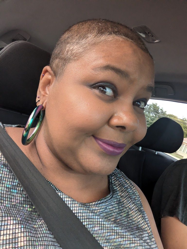 Woman with short hair smiling in car seat