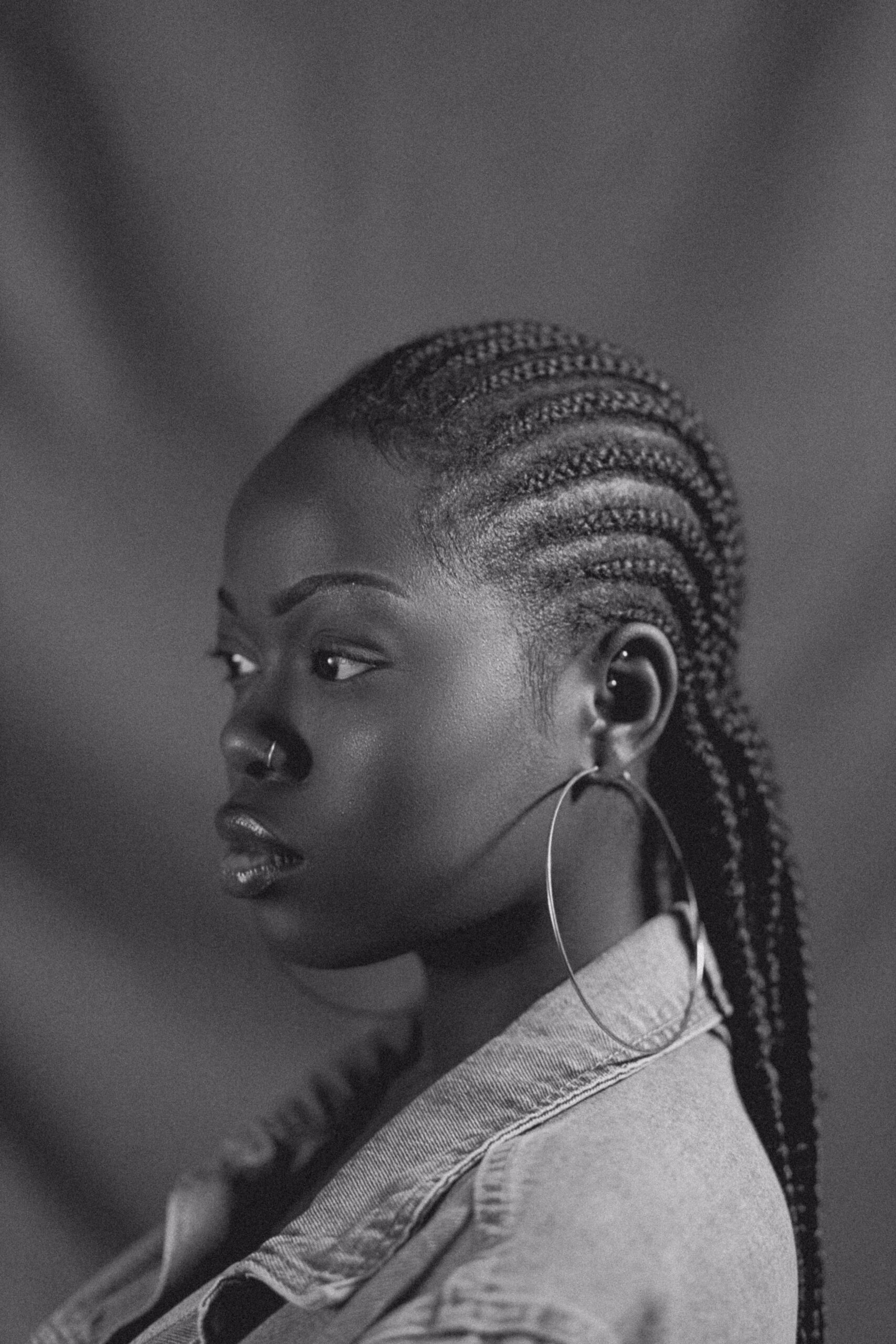 Black-and-white profile portrait of woman with braided hair
