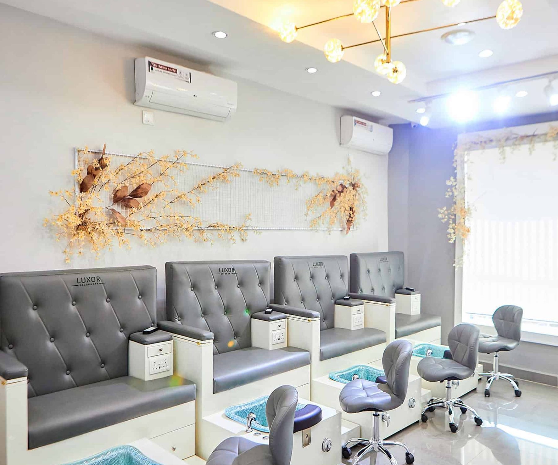 Modern nail salon pedicure stations with grey chairs