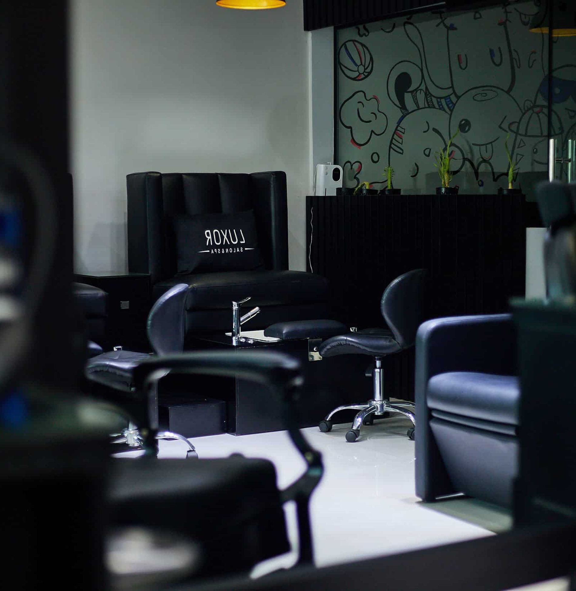 Modern hair salon interior with black styling chairs